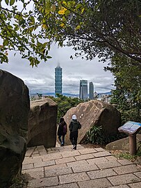 Hikers descending through cut in massive boulders