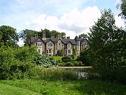 view of large cottage across lake