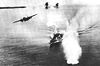 A bomber drops its load on a Japanese warship