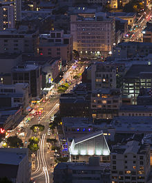 The Hannah Playhouse in the foreground of this night time aerial shot of Wellington's Courtenay Place with the roof lit up as a highlight in the photo.