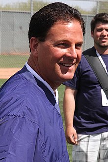 A man in a blue jacket, smiling