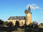 Imposing dressed stone building symmetrically designed in Neo-Gothic style. Greek cross plan with a large high clock tower centrally placed over entrance. Beautifully detailed externally and internally. Type of site: Church Current use: Church : Dutch Reformed.