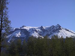 A snow-covered mountain with a jagged flattish top