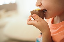 Photo of a boy eating a chocolate egg