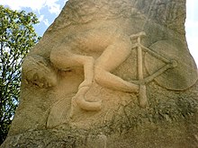 A rock, encarved with an image of a man on a bicycle