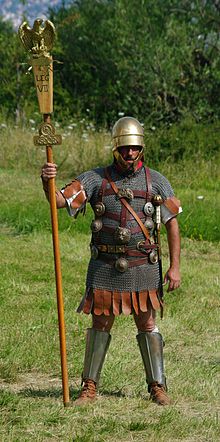 Man in chain armor holding a long staff