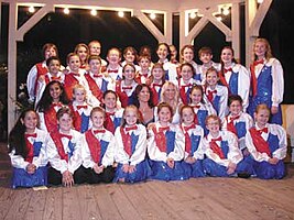 The Junior Guilders posing for a picture in their traditional red, white, and blue sequin outfits.