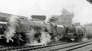 Coronation Class locos changing over at Carlisle on the southbound Royal Scot in 1958. No. 46221 Queen Elizabeth (left) and No. 46240 City of Coventry with headboard ready to climb Shap.