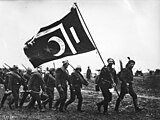 Soldiers carrying a war flag during Balkan Wars, 1912[9]