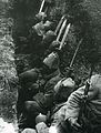 Turkish soldiers in a trench waiting for the order to attack with fixed bayonets on their rifles