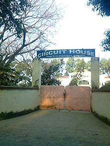 Closed gate with an arch reading "Circuit House"