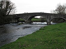 the river flowing under a bridge