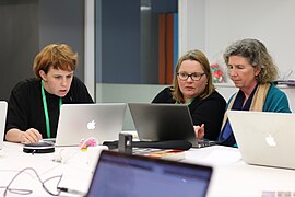 Editors discussing Wikipedia updates at Edit for Equity event in Wellington, New Zealand.