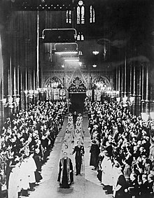 Princess Elizabeth and Phillip Mountbatten process down the aisle of the abbey, followed by bridesmaids.