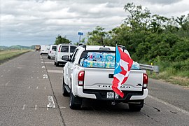 A Toyota Tacoma pick-up truck on PR-52 south, with water and flag, after Hurricane Maria (2017)
