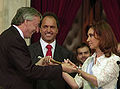 President–elect and outgoing First Lady Cristina Fernández de Kirchner receives the presidential sash and staff from her husband, outgoing president Néstor Kirchner in 2007.