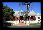 This parsonage building, which was erected in 1819, was enlarged and rebuilt in true Victorian style in 1848 at the request of Dr J. F. Reitz after his appointment as minister to the congregation. Hereafter it served as parsonage until 1948. Type of site: Pastorie Previous use: Parsonage. Current use: Restaurant.