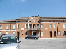 Edifício Grimani, sede do município é um prédio de dois andares, fachada em marrom claro, com portas e janelas brancas.