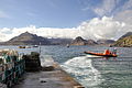 Image 32A boat leaving a slipway stacked with creels in Elgol Bay, Skye, with the Cuillin in the background Credit: Paul Hermans