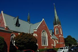 A color photograph of a brick building, a church