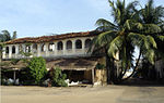 Historical building in colonial style, palms nearby