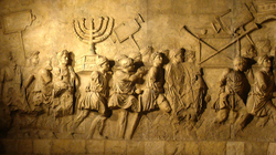 Relief carving depicting Roman soldiers carrying a menorah and other artifacts