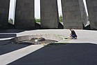 A man lays his remembrance at the memorial