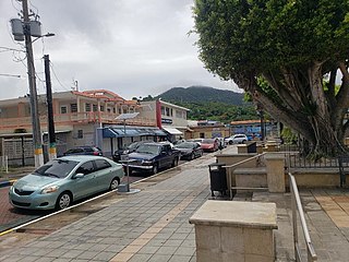 Cars parked around the square (plaza de recreo) of Maunabo barrio-pueblo