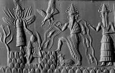 Detail of a cylinder seal from Sippar (2300 BC) depicting Shamash with rays rising from his shoulders and holding a saw-toothed knife with which he cuts his way through the mountains of the east at dawn (British Museum)