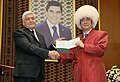 Japanese Prime Minister Shinzo Abe (right) wearing a papakha (telpek) next to rector of the Magtymguly Turkmen State University Gurtnyyaz Nurlyyewic Hanmyradow (left)