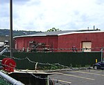 The former North Hawthorne roundhouse building seen from behind a fence in 2012