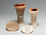 Two vases and lids covered with hieroglyphic inscriptions