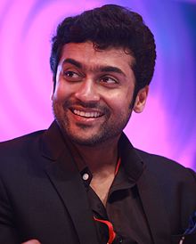 Photograph of actor Suriya, smiling, looking to his right.