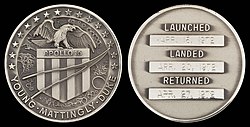 Apollo 16 mission emblem and crew names (front). Dates (launch, lunar landing, and return) (back)