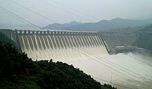 An industrial-sized dam with water flowing through it