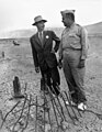 General Leslie Groves and J. Robert Oppenheimer at the site of the Trinity explosion in September 1945.