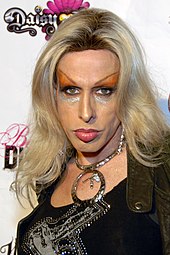 Alexis Arquette looking to the camera, in heavy eye makeup.