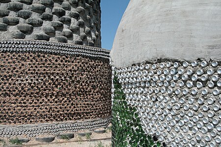 Tire and bottle walls of earthships