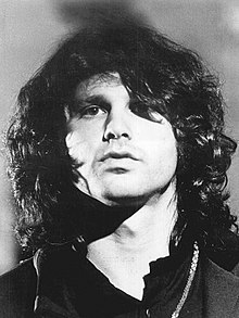 Photograph of Jim Morrison looking into the camera.