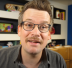 John Green sporting a mustache during "Pizzamas".