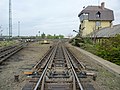 Image 19The "hump" of a hump yard. Railcars travel past retarders, which control their speed, and are directed onto tracks to be assembled into new trains. The control tower operates the retarders. (from Rail yard)