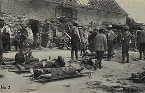 men on stretchers with medical staff standing