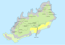 Carte en couleurs montrant une île entourée d'eau, avec de nombreux points signalant la présence de bunkers ou de canons.