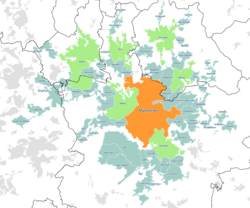 A map of the Greater Manchester Built-up Area according to the 2011 census, with Travel to Work Areas overlaid. Manchester is highlighted in orange