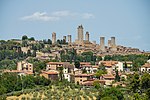 A small town dominated by many tall stone towers