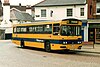 A yellow bus with a dark blue stripe running its length; the bus number is 50 and its destination says Cranleigh.