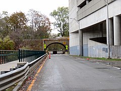 A sidewalk and road next to a parking garage