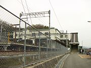 Train station with tracks and wires overhead