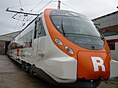 The front side of a Civia train. A big 'R' (standing for Rodalies de Catalunya) is painted on the front.