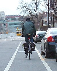 Cyclist riding in a bike lane situated in a door zone